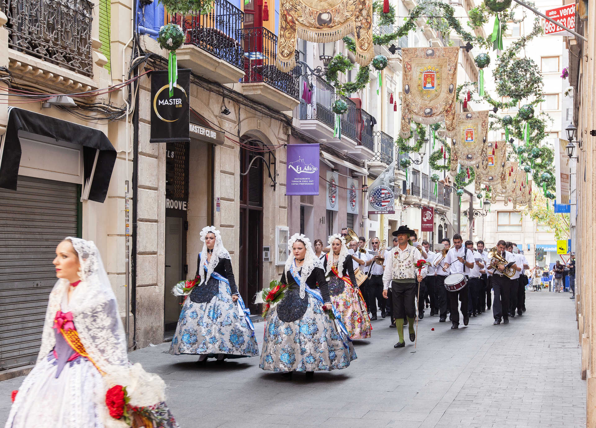 A parade of women from Alicante wearing the traditional dress of the Hogueras de San Juan in Alicante.