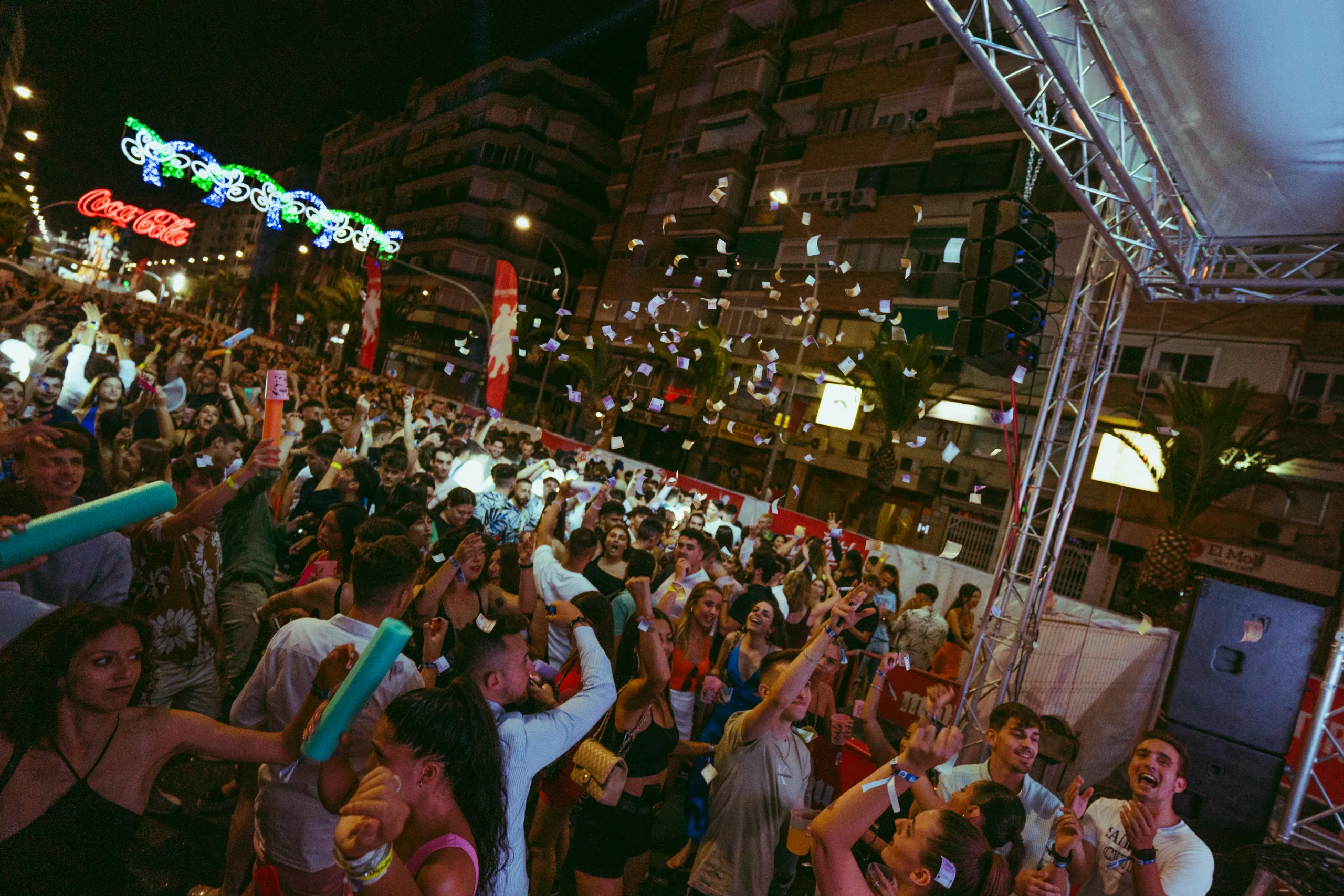 A barraca at the Hogueras de Alicante festival, filled with people enjoying a lively concert and having a great time.