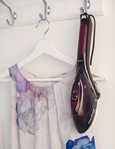 Rowenta DV8613 steam iron hanging on a hook against a neutral background.