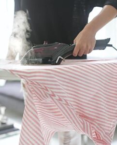 Rowenta DV8613 steam iron in use, ironing clothes with visible steam on fabric.