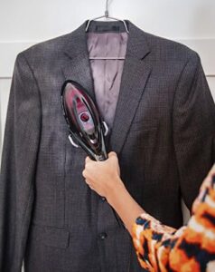 Rowenta DV8613 steam iron being used on a suit jacket, smoothing wrinkles with steam.