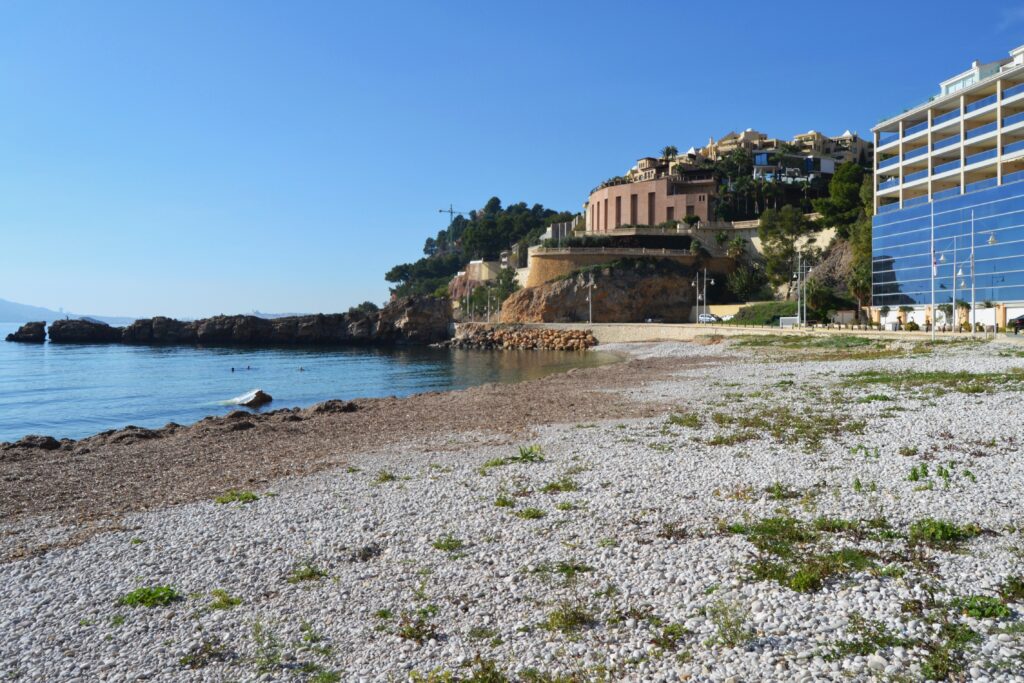 photo of mascarat beach with dunes and nature in the background